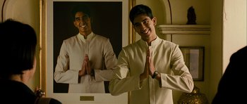 Movie still from “The Best Exotic Marigold Hotel” (2011), directed by John Madden – A man in a white shirt and a picture of a man; Medium shot, Low angle