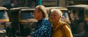 Movie still from “The Best Exotic Marigold Hotel” (2011), directed by John Madden – An older man and woman riding on a motorcycle; Close Up shot, Low angle