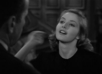 Movie still from “The Big Sleep” (1946), directed by Howard Hawks – A black - and - white photo of a woman in a black shirt; Close Up shot, Over the shoulder angle