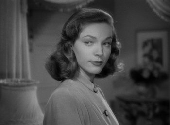 Movie still from “The Big Sleep” (1946), directed by Howard Hawks – A black - and - white photo of a woman in a dress; Close Up shot, Over the shoulder angle