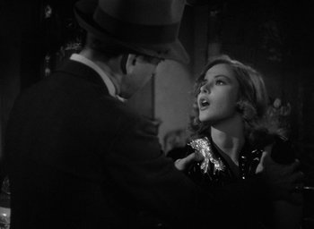 Movie still from “The Big Sleep” (1946), directed by Howard Hawks – A man and a woman in a black and white photo; Close Up shot, Over the shoulder angle