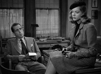 Movie still from “The Big Sleep” (1946), directed by Howard Hawks – A man and a woman sitting in a room; Medium shot, Over the shoulder angle