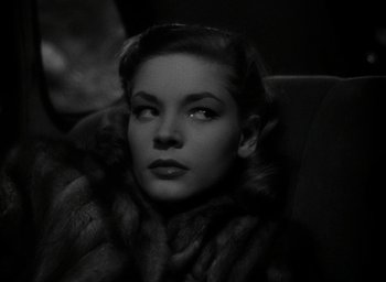 Movie still from “The Big Sleep” (1946), directed by Howard Hawks – A black and white photo of a woman in a fur coat; Close Up shot, Low angle