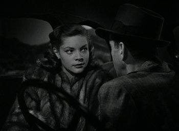 Movie still from “The Big Sleep” (1946), directed by Howard Hawks – A man and a woman are looking at one another; Close Up shot, Over the shoulder angle