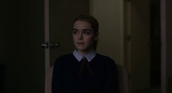 Movie still from “The Blackcoat's Daughter” (2015), directed by Oz Perkins – A woman in a black shirt and a red tie; Close Up shot, Over the shoulder angle