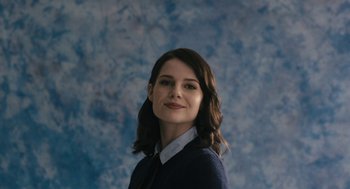 Movie still from “The Blackcoat's Daughter” (2015), directed by Oz Perkins – A woman in a blue shirt is smiling for the camera; Close Up shot, Low angle