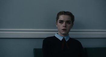 Movie still from “The Blackcoat's Daughter” (2015), directed by Oz Perkins – A woman in a black shirt and a red tie; Close Up shot, Over the shoulder angle