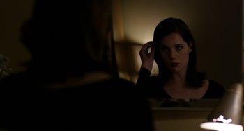 Movie still from “The Blackcoat's Daughter” (2015), directed by Oz Perkins – A woman sitting in front of a mirror looking at herself in the mirror; Close Up shot, Over the shoulder angle