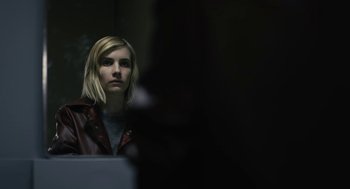Movie still from “The Blackcoat's Daughter” (2015), directed by Oz Perkins – A woman with blonde hair wearing a leather jacket; Close Up shot, Over the shoulder angle