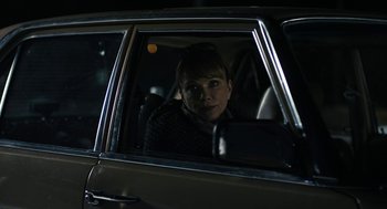 Movie still from “The Blackcoat's Daughter” (2015), directed by Oz Perkins – A woman sitting in the passenger seat of a car at night; Close Up shot, Over the shoulder angle