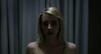 Movie still from “The Blackcoat's Daughter” (2015), directed by Oz Perkins – A woman with blonde hair is staring straight ahead; Close Up shot, Overhead angle