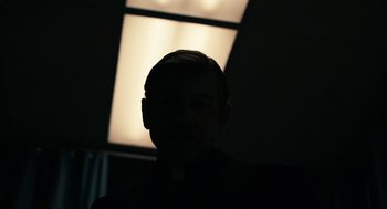 Movie still from “The Blackcoat's Daughter” (2015), directed by Oz Perkins – A man with a beard and mustache in the dark; Close Up shot, Low angle