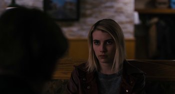 Movie still from “The Blackcoat's Daughter” (2015), directed by Oz Perkins – A woman sitting in front of a brick wall; Close Up shot, Over the shoulder angle