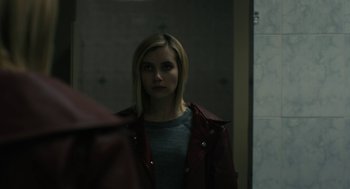 Movie still from “The Blackcoat's Daughter” (2015), directed by Oz Perkins – A woman is standing in front of a bathroom mirror; Close Up shot, Over the shoulder angle