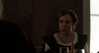 Movie still from “The Blackcoat's Daughter” (2015), directed by Oz Perkins – A woman sitting in front of a mirror looking into the mirror; Close Up shot, Over the shoulder angle