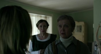 Movie still from “The Blackcoat's Daughter” (2015), directed by Oz Perkins – Two women are looking at each other in a room; Medium shot, Over the shoulder angle
