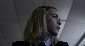 Movie still from “The Blackcoat's Daughter” (2015), directed by Oz Perkins – A young woman with blonde hair wearing a dress shirt and tie; Close Up shot, Low angle