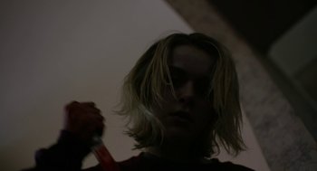 Movie still from “The Blackcoat's Daughter” (2015), directed by Oz Perkins – A woman holding a pair of scissors in her hand; Close Up shot, Low angle