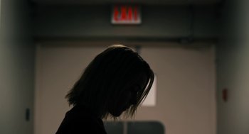 Movie still from “The Blackcoat's Daughter” (2015), directed by Oz Perkins – A woman with her head turned to the side; Close Up shot, Low angle