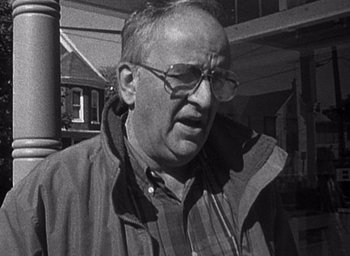 Movie still from “The Blair Witch Project” (1999), directed by Eduardo Sánchez – An older man wearing glasses and a jacket; Close Up shot, Low angle