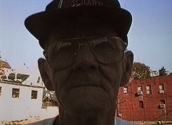 Movie still from “The Blair Witch Project” (1999), directed by Eduardo Sánchez – An old man wearing glasses and a hat; Close Up shot, Low angle