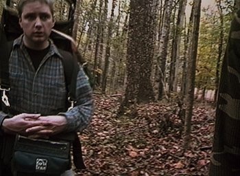 Movie still from “The Blair Witch Project” (1999), directed by Eduardo Sánchez – A man standing in the middle of a forest; Medium shot, High angle