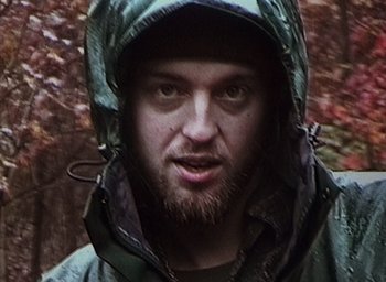 Movie still from “The Blair Witch Project” (1999), directed by Eduardo Sánchez – A person wearing a jacket; Close Up shot, High angle
