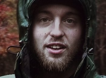 Movie still from “The Blair Witch Project” (1999), directed by Eduardo Sánchez – A person wearing a jacket; Extreme Close Up shot, Low angle