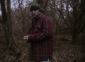 Movie still from “The Blair Witch Project” (1999), directed by Eduardo Sánchez – A man standing in the middle of a forest; Medium shot, Low angle