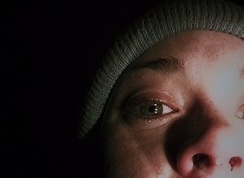 Movie still from “The Blair Witch Project” (1999), directed by Eduardo Sánchez – A person's eyes with a hat on; Extreme Close Up shot, Overhead angle