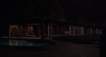 Movie still from “The Bling Ring” (2013), directed by Sofia Coppola – A night time shot of a pool and a house; Extreme Wide shot, Low angle