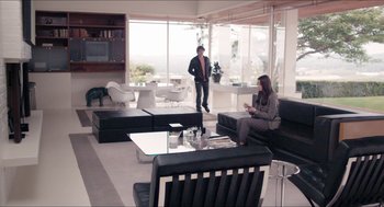 Movie still from “The Bling Ring” (2013), directed by Sofia Coppola – Two people are sitting in a living room; Wide shot, High angle