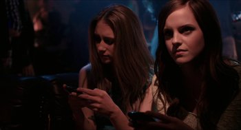 Movie still from “The Bling Ring” (2013), directed by Sofia Coppola – Two young women looking at their cell phones; Close Up shot, Low angle
