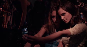 Movie still from “The Bling Ring” (2013), directed by Sofia Coppola – Two young women taking a picture of themselves with a cell phone; Medium shot, Low angle