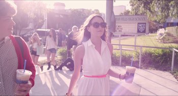 Movie still from “The Bling Ring” (2013), directed by Sofia Coppola – A woman in a white sundress holding a cup of coffee; Medium shot, Low angle