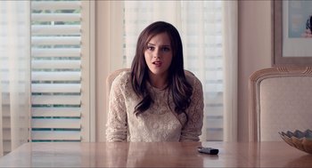 Movie still from “The Bling Ring” (2013), directed by Sofia Coppola – A beautiful young lady sitting at a wooden table; Close Up shot, Over the shoulder angle