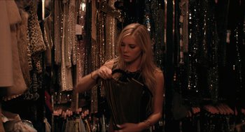 Movie still from “The Bling Ring” (2013), directed by Sofia Coppola – A beautiful young woman holding a purse in a store; Medium shot, Over the shoulder angle