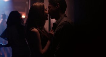 Movie still from “The Bling Ring” (2013), directed by Sofia Coppola – A man and a woman kissing in a dark room; Close Up shot, Over the shoulder angle