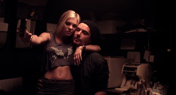 Movie still from “The Bling Ring” (2013), directed by Sofia Coppola – A man and a woman posing for a picture; Medium shot, Low angle