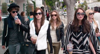 Movie still from “The Bling Ring” (2013), directed by Sofia Coppola – Two young women walking down the street with a drink; Medium shot, High angle