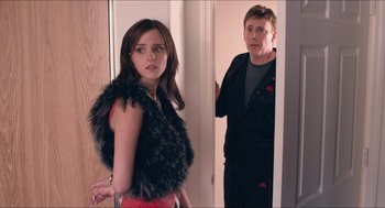 Movie still from “The Bling Ring” (2013), directed by Sofia Coppola – A man and a woman standing next to each other in front of a door; Medium shot, Over the shoulder angle