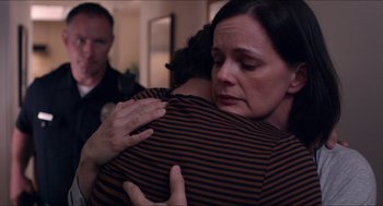 Movie still from “The Bling Ring” (2013), directed by Sofia Coppola – A woman is hugging a man in a room; Close Up shot, Over the shoulder angle