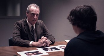 Movie still from “The Bling Ring” (2013), directed by Sofia Coppola – An older man sitting at a table talking to a young woman; Medium shot, Over the shoulder angle