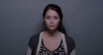 Movie still from “The Bling Ring” (2013), directed by Sofia Coppola – A woman with long black hair wearing a black and white top; Close Up shot, Low angle