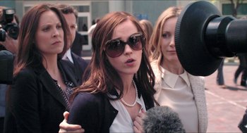 Movie still from “The Bling Ring” (2013), directed by Sofia Coppola – A group of people standing next to each other on a street; Close Up shot, Over the shoulder angle