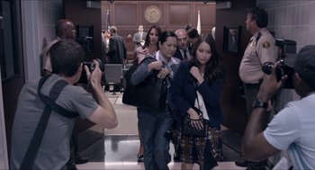 Movie still from “The Bling Ring” (2013), directed by Sofia Coppola – A group of people standing in front of a courtroom; Medium shot, High angle