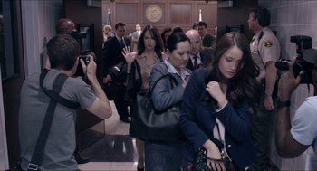 Movie still from “The Bling Ring” (2013), directed by Sofia Coppola – A group of people walking in a hallway; Medium shot, Over the shoulder angle