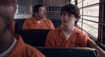Movie still from “The Bling Ring” (2013), directed by Sofia Coppola – A man and a woman in orange prison uniforms; Medium shot, Over the shoulder angle