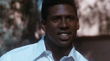 Movie still from “The Bodyguard” (1992), directed by Mick Jackson – A person wearing a white shirt; Close Up shot, Low angle