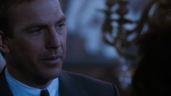 Movie still from “The Bodyguard” (1992), directed by Mick Jackson – A man in a suit and tie; Close Up shot, Over the shoulder angle